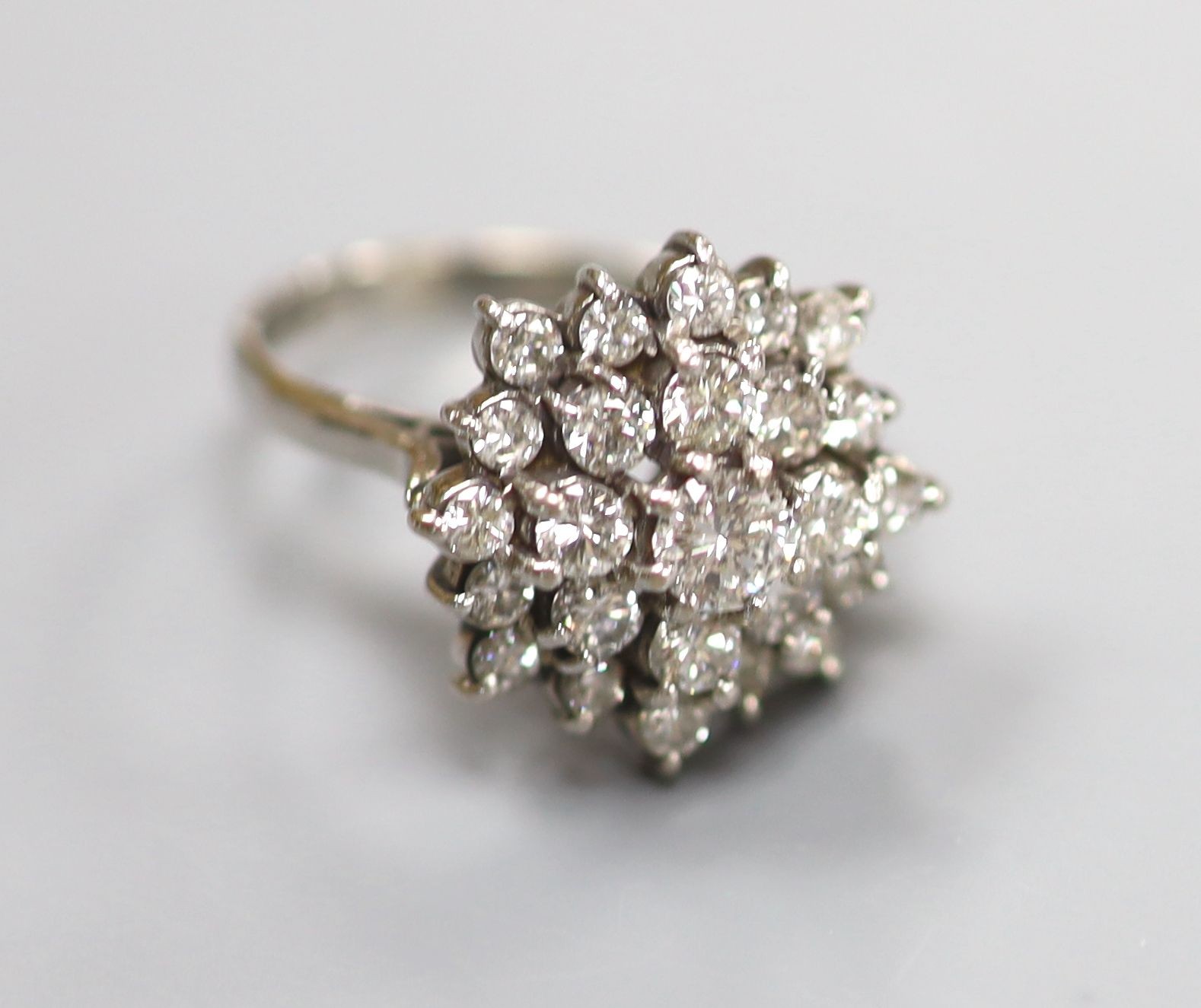 A modern 18ct white gold and diamond set flower head cluster ring, size M, gross weight 6.6 grams.